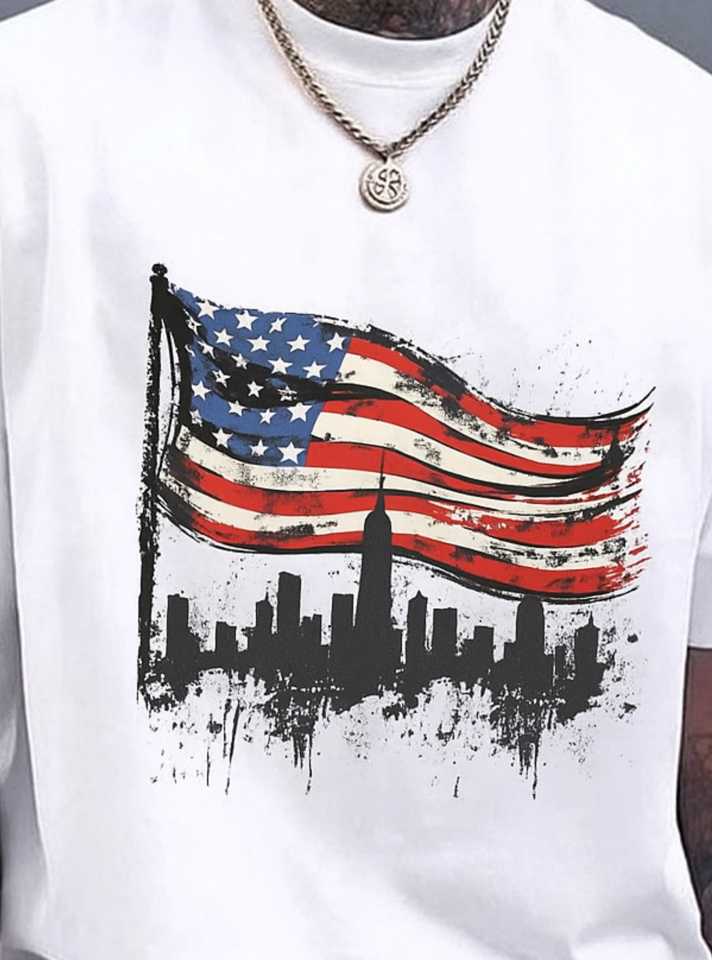 White oversized T-shirt featuring a bold American flag graphic with a New York City skyline design, modern streetwear style for men.
