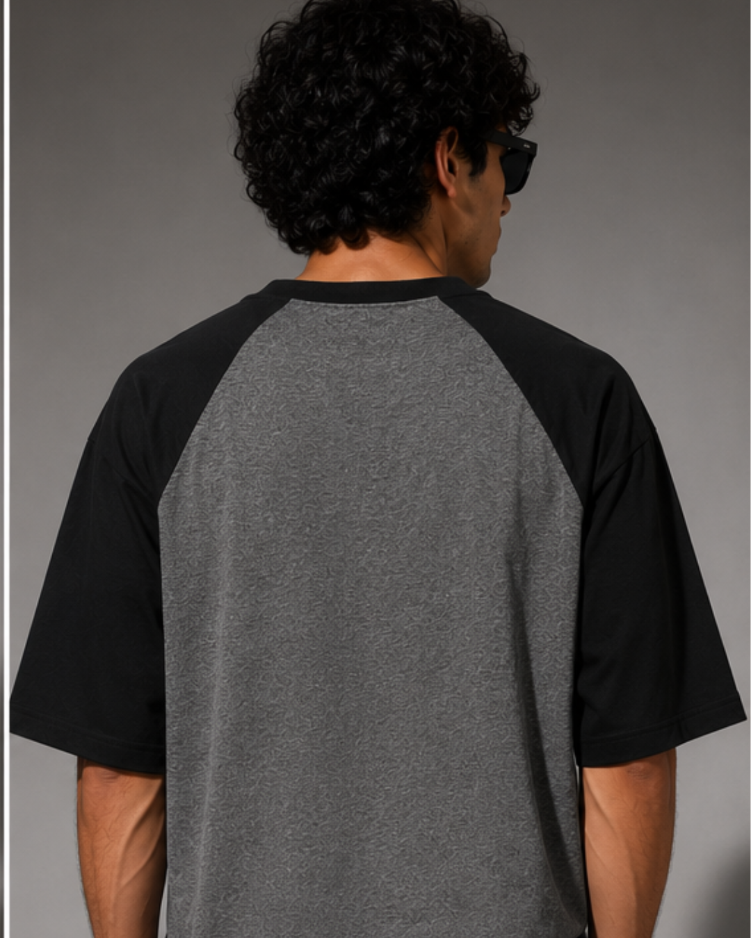 Black and Charcoal Melange oversized raglan T-shirt for men and women featuring a premium 180 GSM cotton melange fabric, drop shoulder fit, half sleeves, and Parker graphic print by White Bear Clothing.