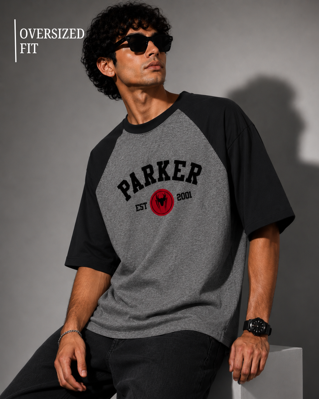 Black and Charcoal Melange oversized raglan T-shirt for men and women featuring a premium 180 GSM cotton melange fabric, drop shoulder fit, half sleeves, and Parker graphic print by White Bear Clothing.