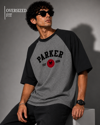 Black and Charcoal Melange oversized raglan T-shirt for men and women featuring a premium 180 GSM cotton melange fabric, drop shoulder fit, half sleeves, and Parker graphic print by White Bear Clothing.