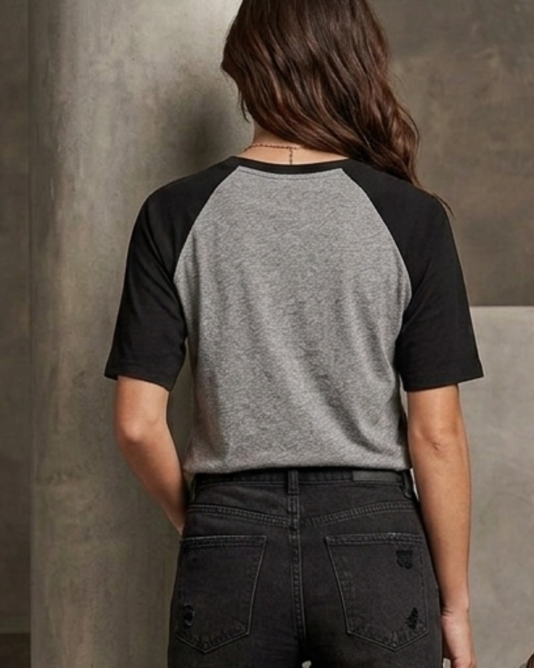 Female model wearing a black and white oversized raglan T-shirt with half sleeves and black star print