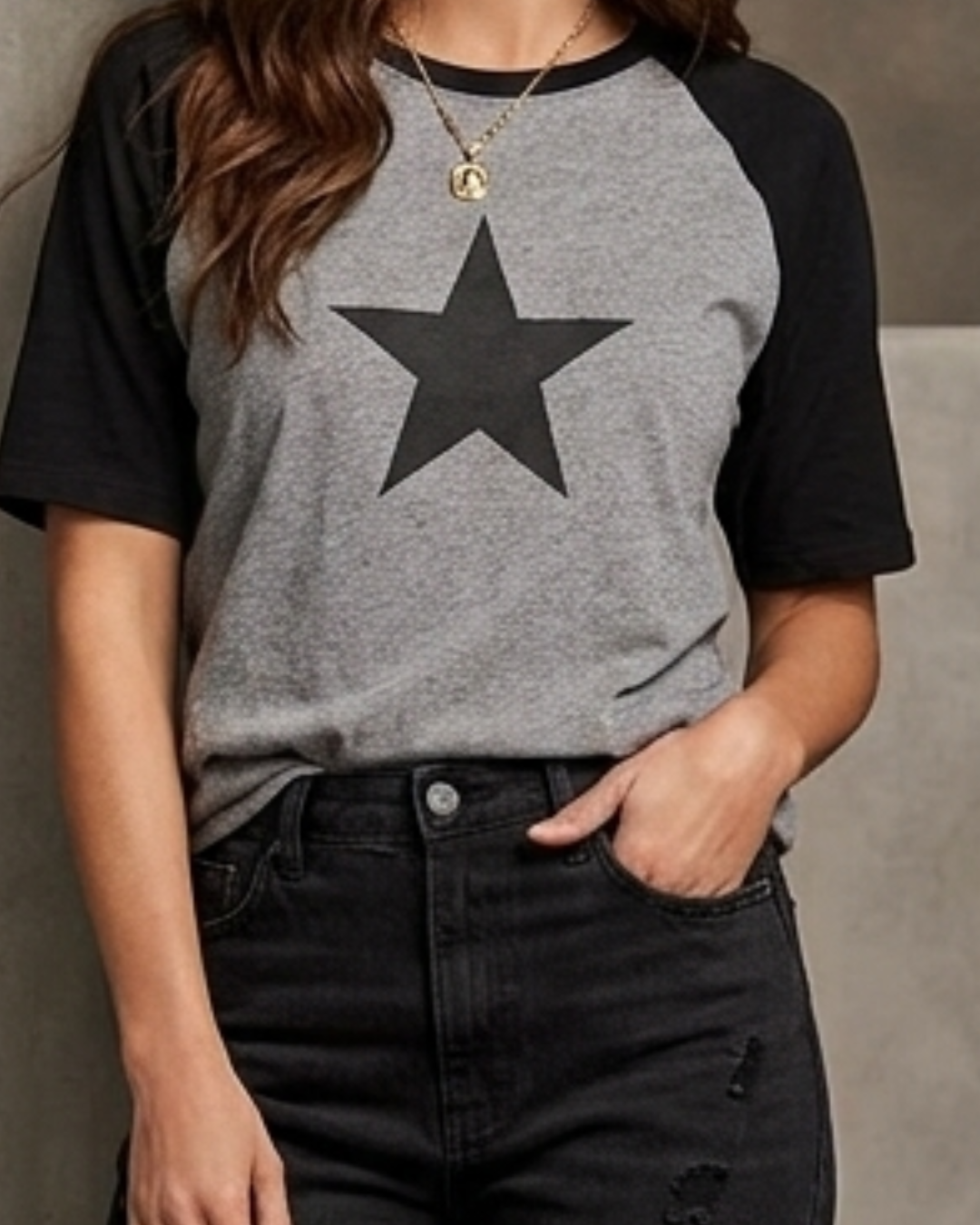 Female model wearing a black and white oversized raglan T-shirt with half sleeves and black star print