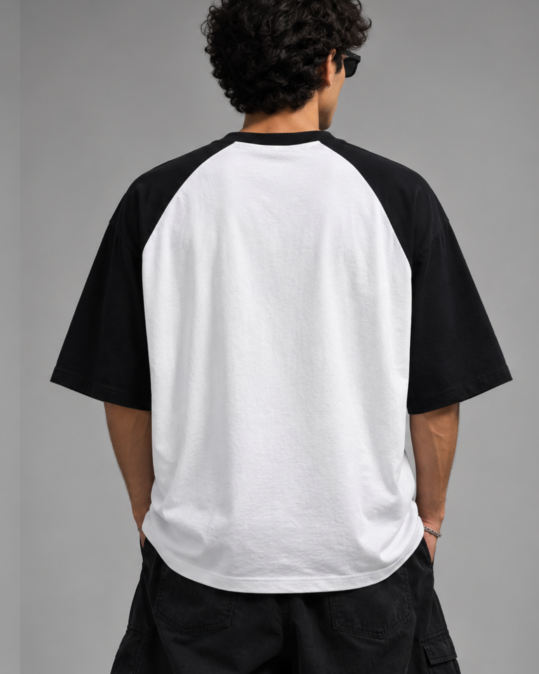 Black and white oversized raglan T-shirt for men and women featuring a premium 180 GSM cotton melange fabric, drop shoulder fit, half sleeves, and Parker graphic print by White Bear Clothing.