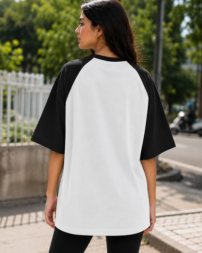 Female model wearing a black and white oversized raglan T-shirt with half sleeves and black star print