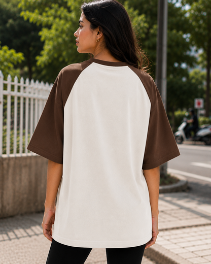 Female model wearing a black and white oversized raglan T-shirt with half sleeves and black star print