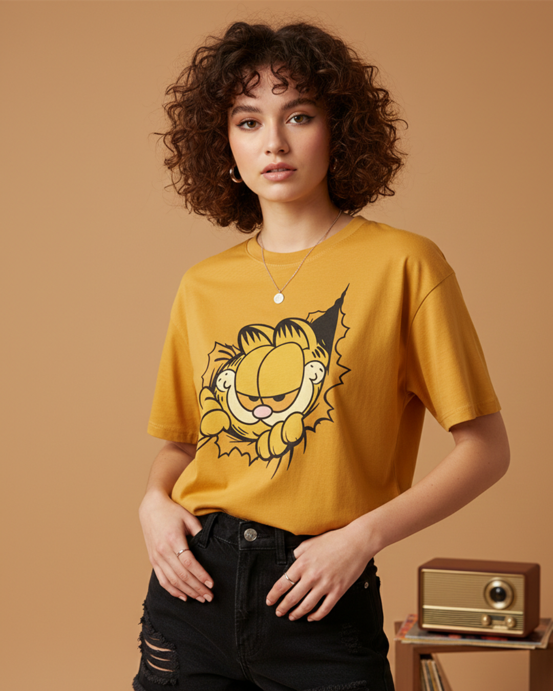 Woman wearing a mustard yellow t-shirt with a cartoon character on a brown background