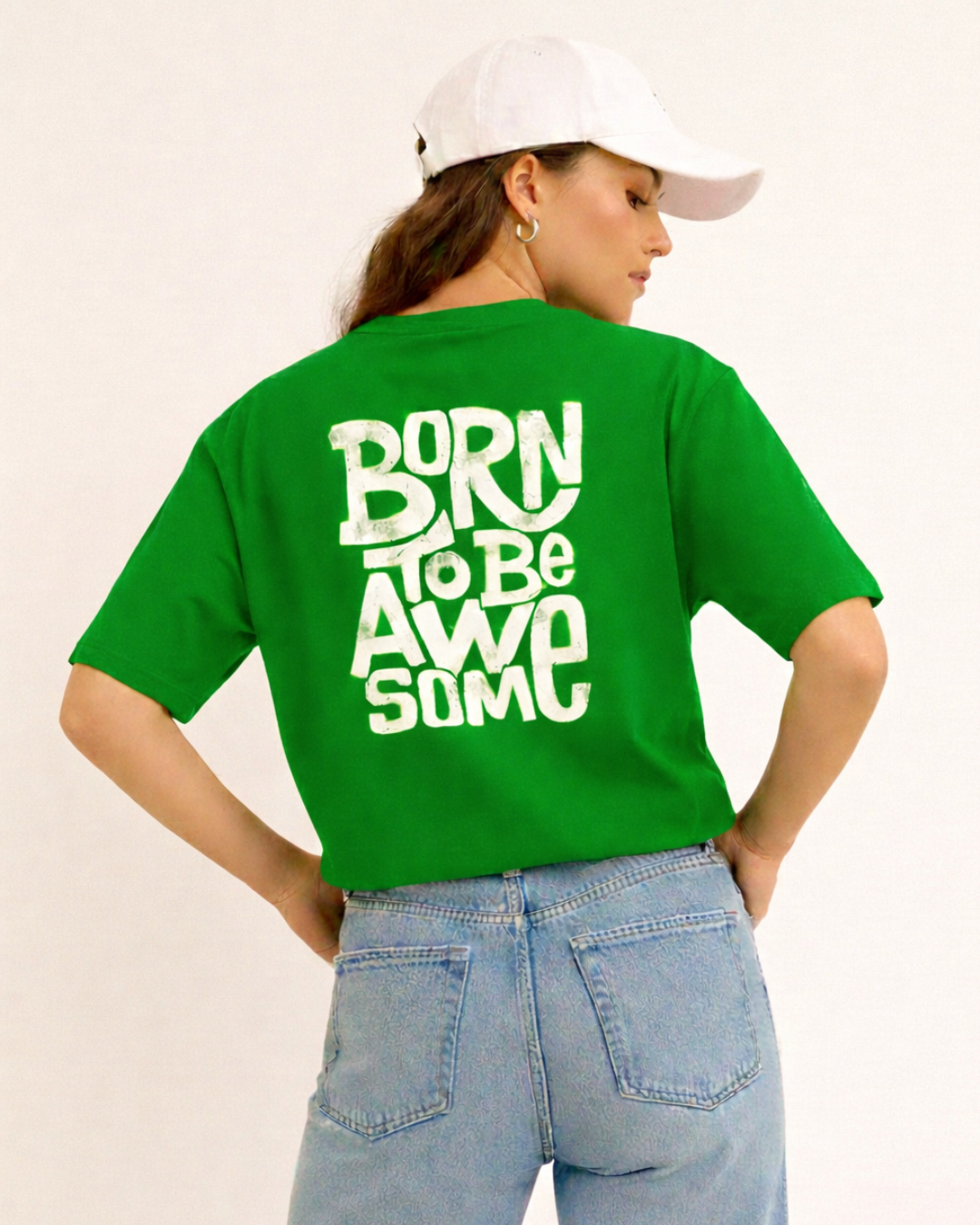 Person wearing a green t-shirt with 'Born to be Awesome' text on the back, standing against a plain background.