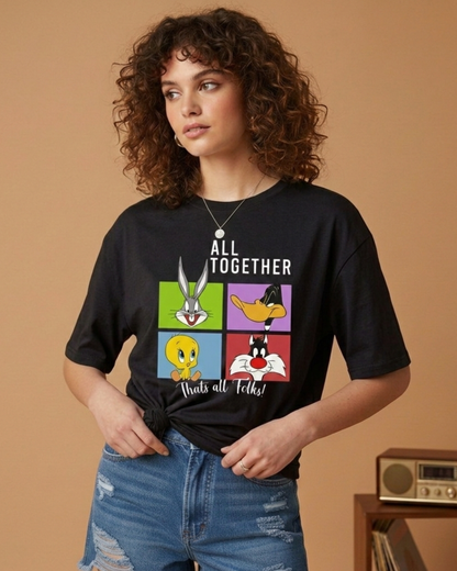 Person wearing a black t-shirt with Looney Tunes characters and text on a beige background