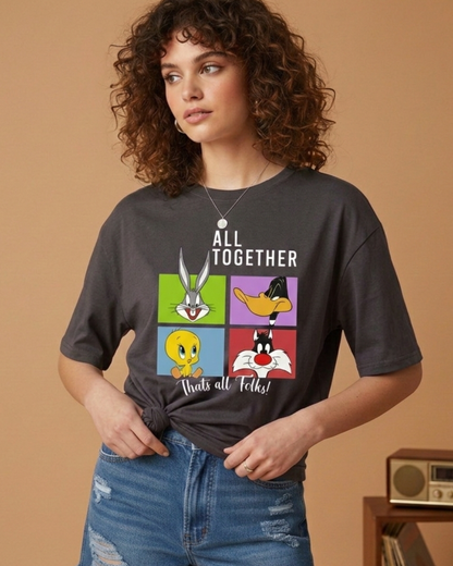 Person wearing a black t-shirt with cartoon character graphics and text on a beige background