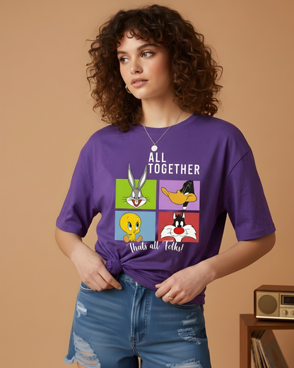 Person wearing a purple t-shirt with cartoon character graphics and text on a beige background