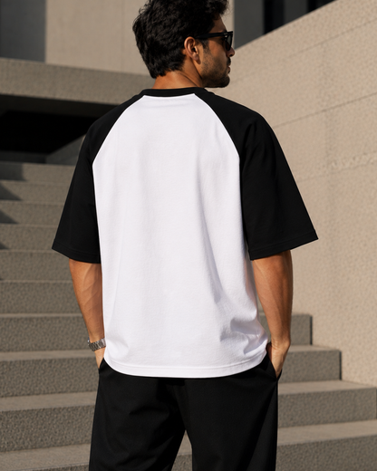Men wearing oversized black and white raglan T-shirt made from 100% cotton 180 GSM premium streetwear oversized fit from white bear brand