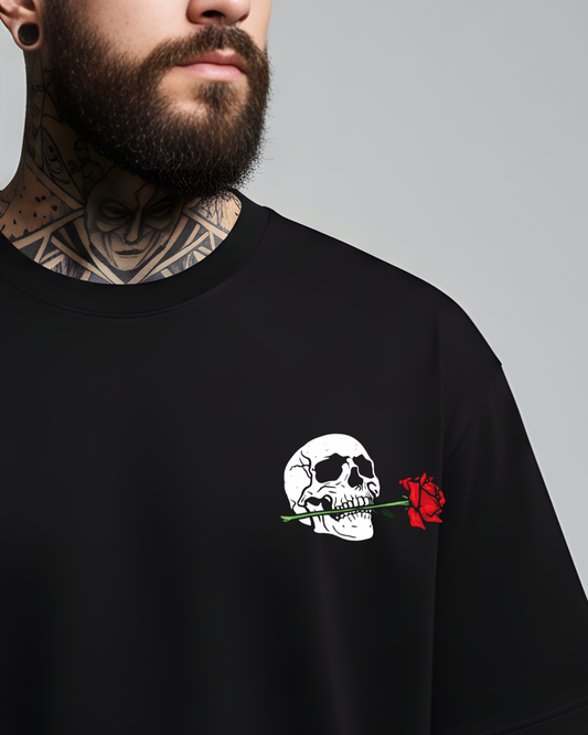 Black t-shirt with skull and red rose design worn by a person with tattoos on a gray background