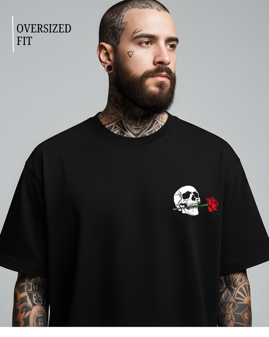 Man wearing a black t-shirt with a skull and rose design on a gray background