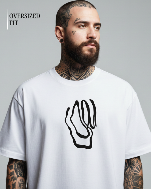 Man wearing a white oversized t-shirt with a black graphic design on a gray background