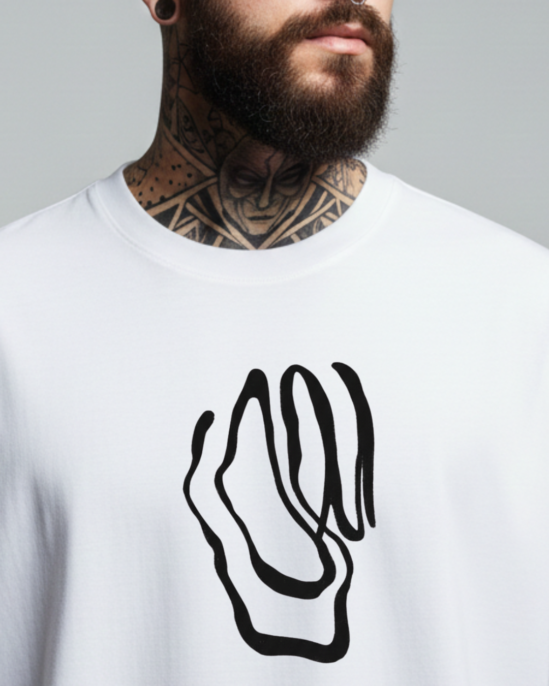 Person wearing a white t-shirt with a black abstract design on a gray background