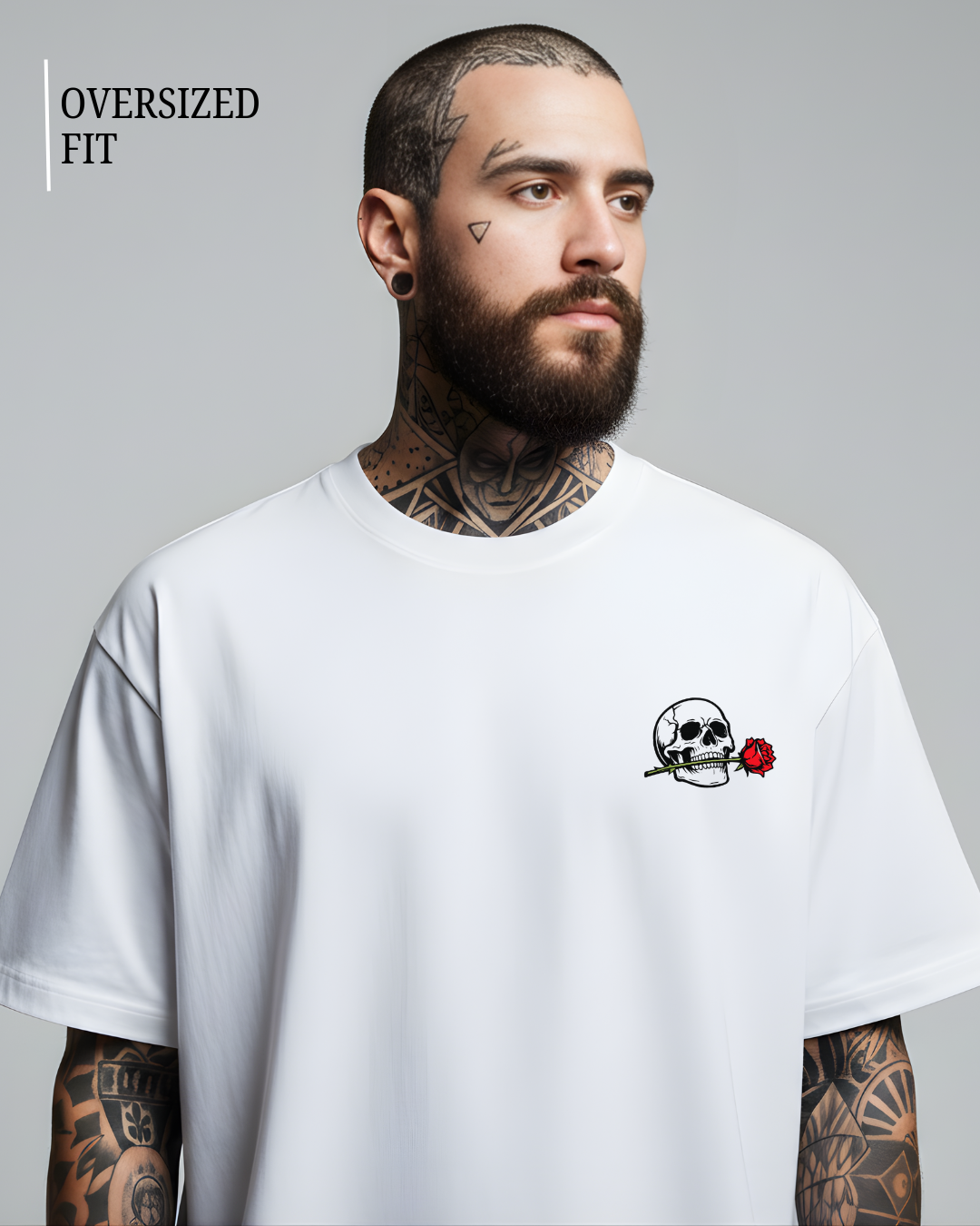 Man wearing a white oversized t-shirt with a skull and rose design on a gray background
