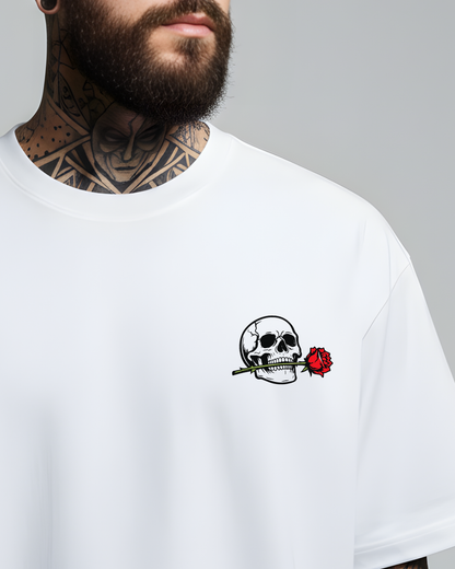 White t-shirt with a skull and rose design on a gray background