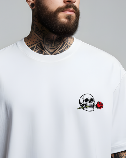 Man wearing a white t-shirt with a skull and rose design on a gray background