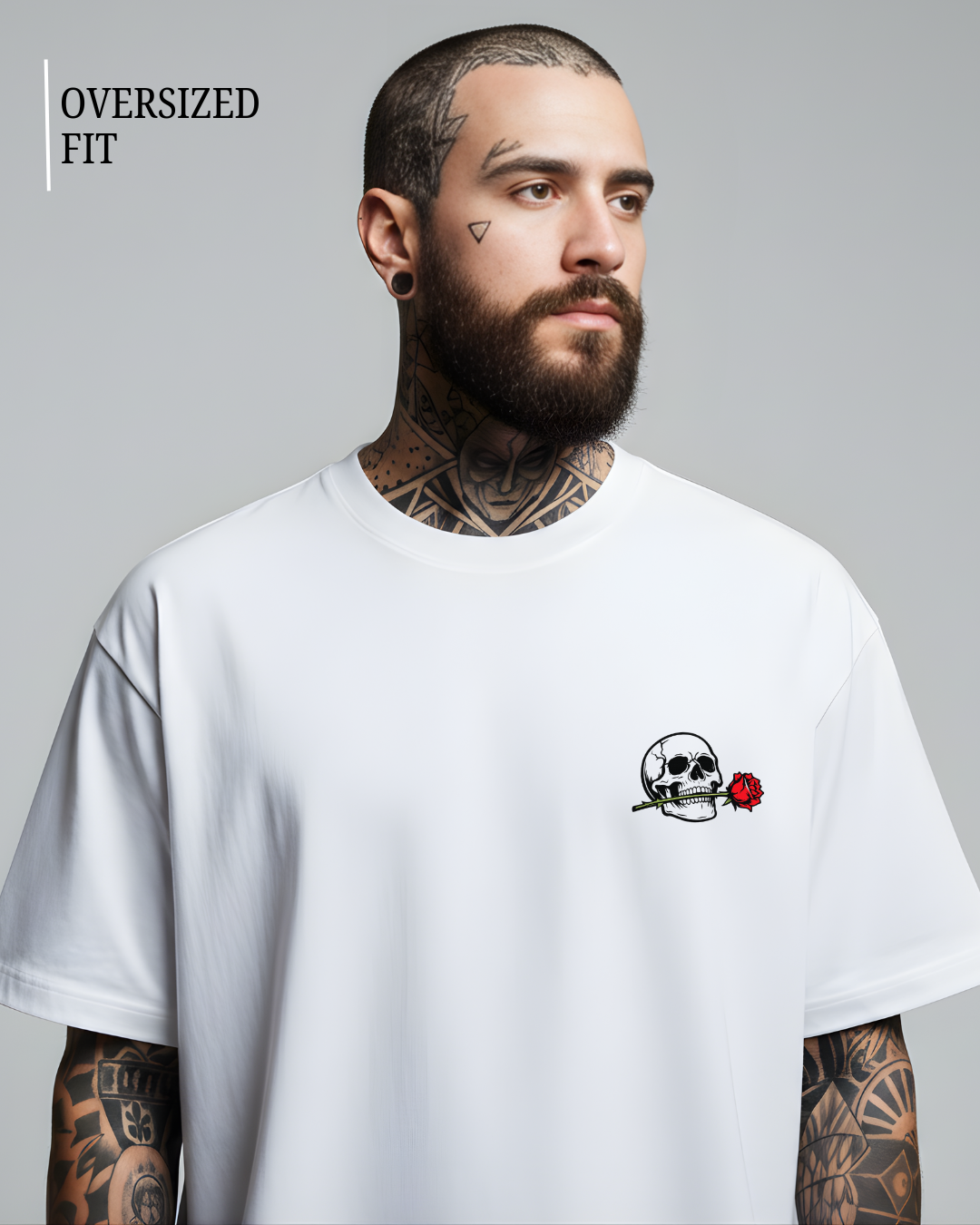 Man wearing a white oversized t-shirt with a skull and rose design on a gray background