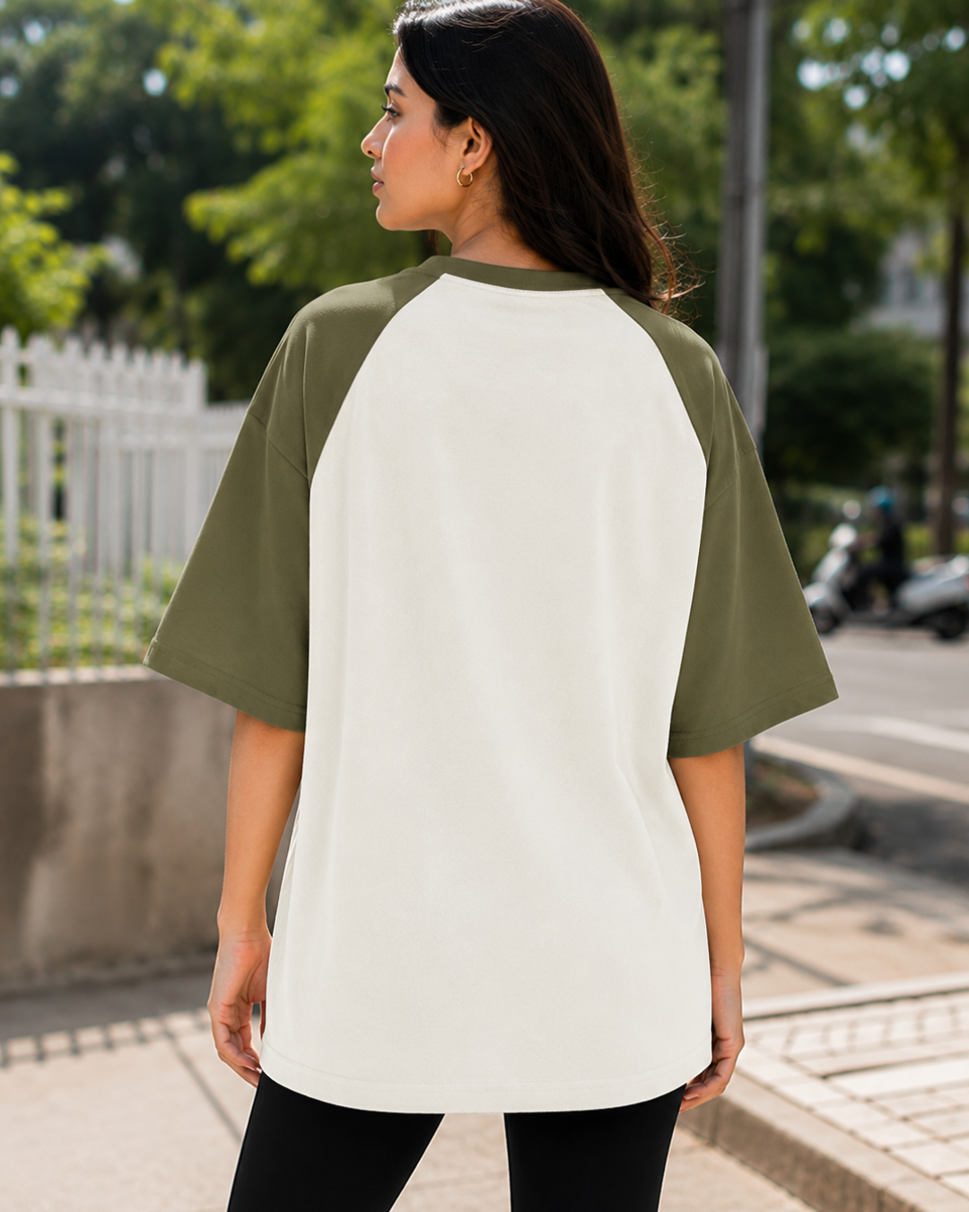Female model wearing a black and white oversized raglan T-shirt with half sleeves and black star print