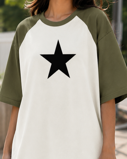 Female model wearing a black and white oversized raglan T-shirt with half sleeves and black star print