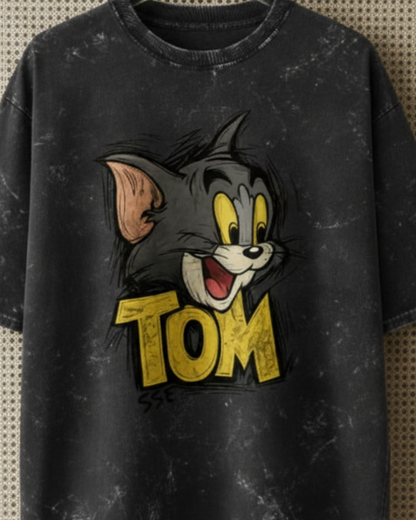Black t-shirt with cartoon character and 'Tom' text on a textured background