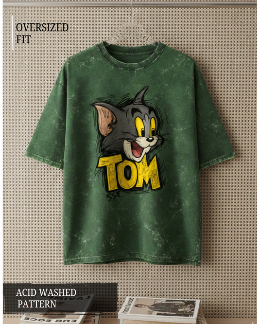 Green acid-washed t-shirt with cartoon character and 'Tom' text on a textured surface.