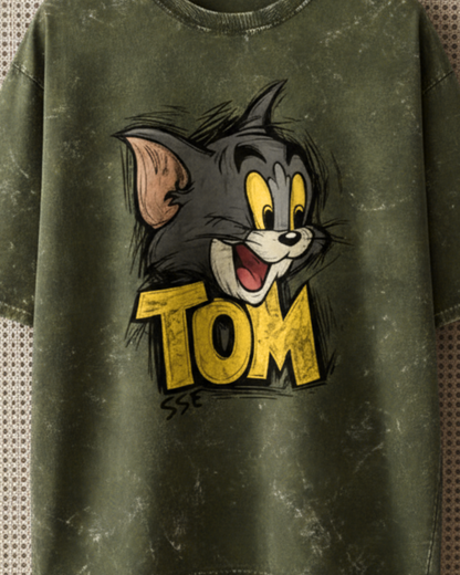 Green t-shirt with a cartoon character and 'Tom' text on a textured background