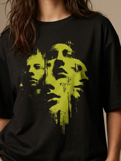 Black t-shirt with green graphic design on a neutral background