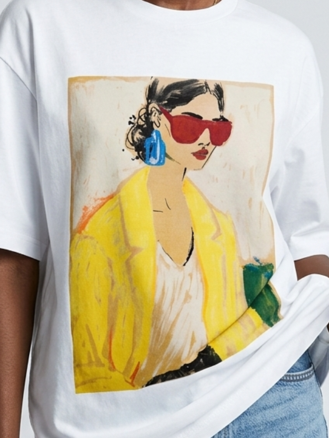 White t-shirt with a graphic of a woman in a yellow dress and red sunglasses.