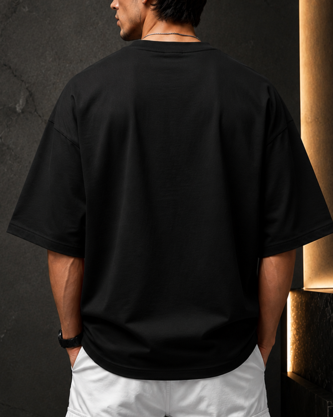 Premium black oversized men's t-shirt back view made from 260 GSM heavyweight terry cotton with dropped shoulders, relaxed fit, soft fabric, and minimalist streetwear style.