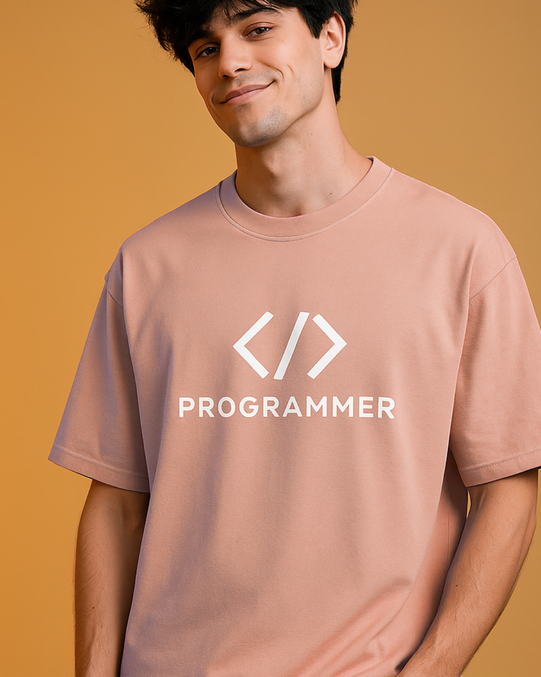Person wearing a pink t-shirt with 'PROGRAMMER' and code symbols on a beige background