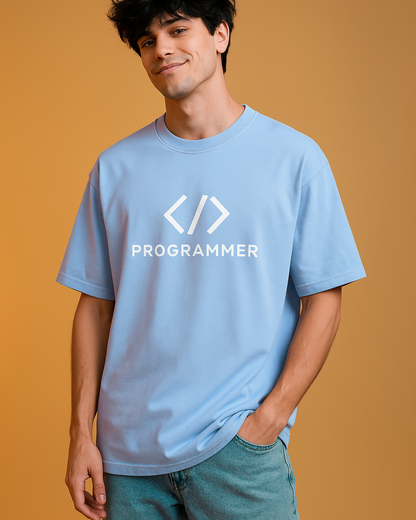 Person wearing a light blue t-shirt with 'PROGRAMMER' and code symbols on a beige background