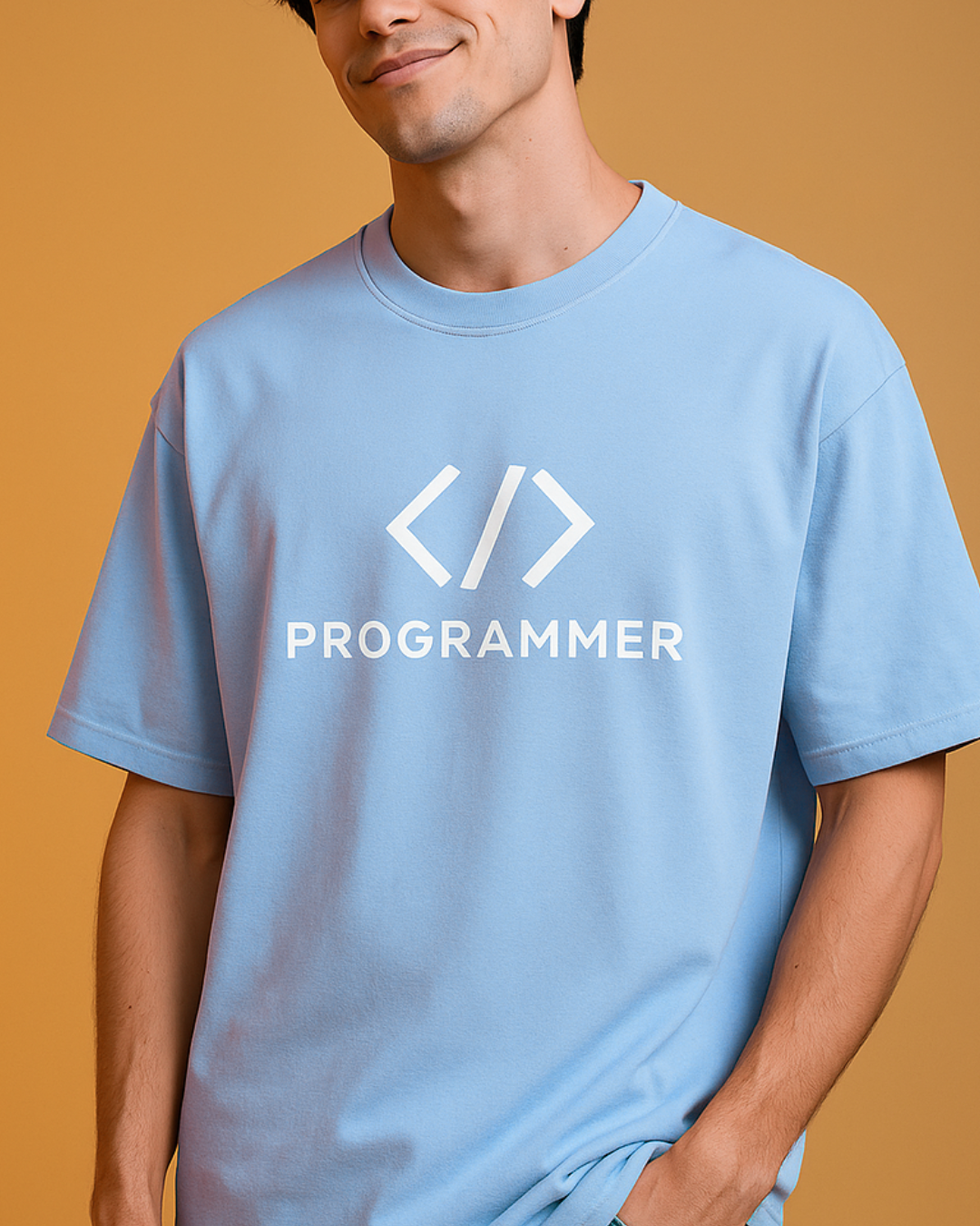 Person wearing a light blue t-shirt with 'PROGRAMMER' text and symbols on a mustard yellow background