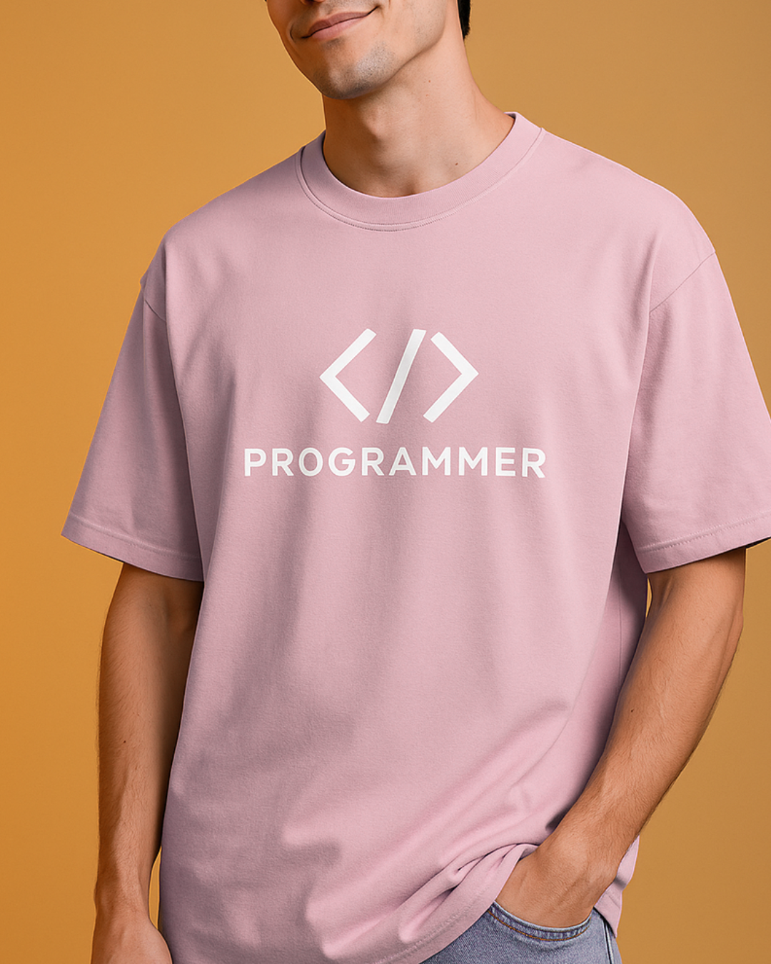 Person wearing a pink t-shirt with a 'PROGRAMMER' logo on a mustard yellow background