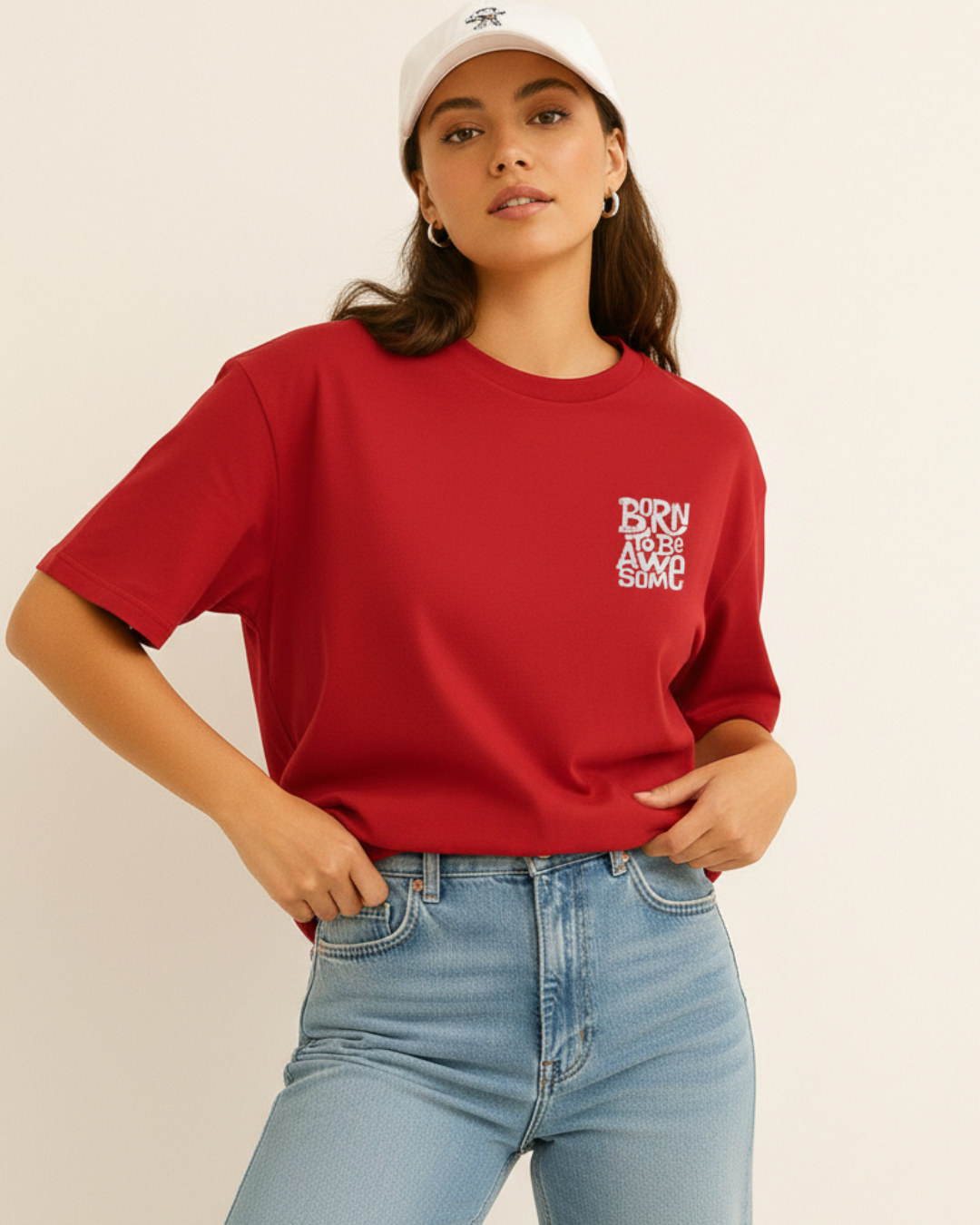 Person wearing a red t-shirt with text and light blue jeans on a beige background