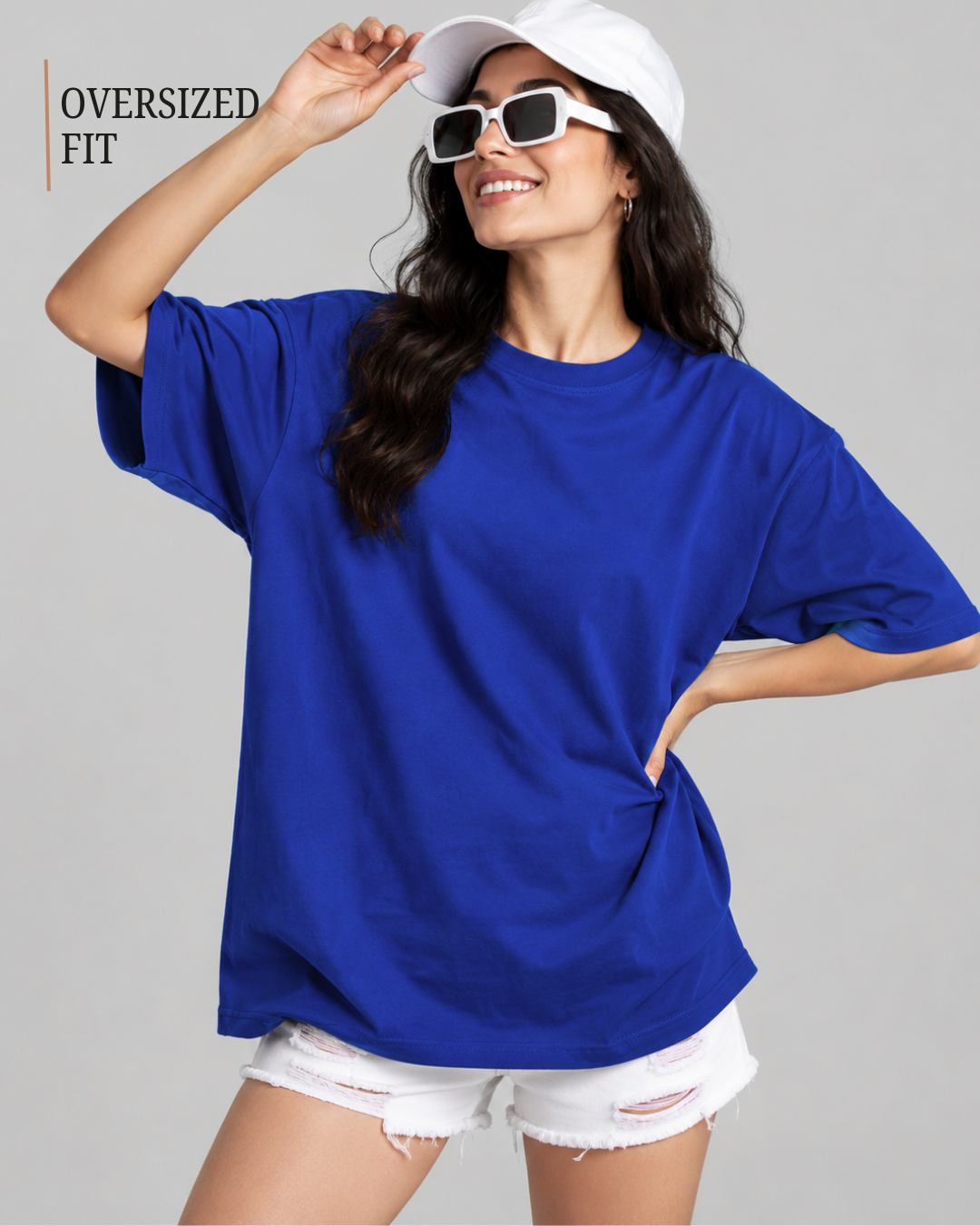 A woman modeling an oversized royal blue t-shirt with white distressed denim shorts from white bear brand