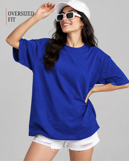 A woman modeling an oversized royal blue t-shirt with white distressed denim shorts from white bear brand