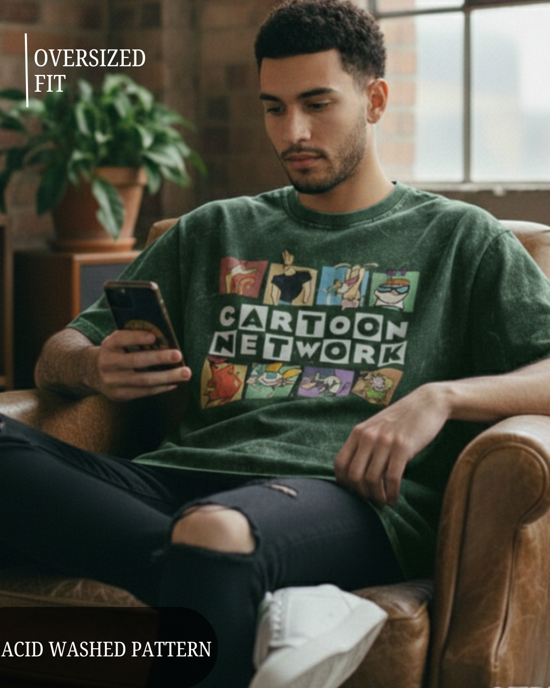 Man wearing a green 'Cartoon Network' t-shirt sitting on a leather chair.
