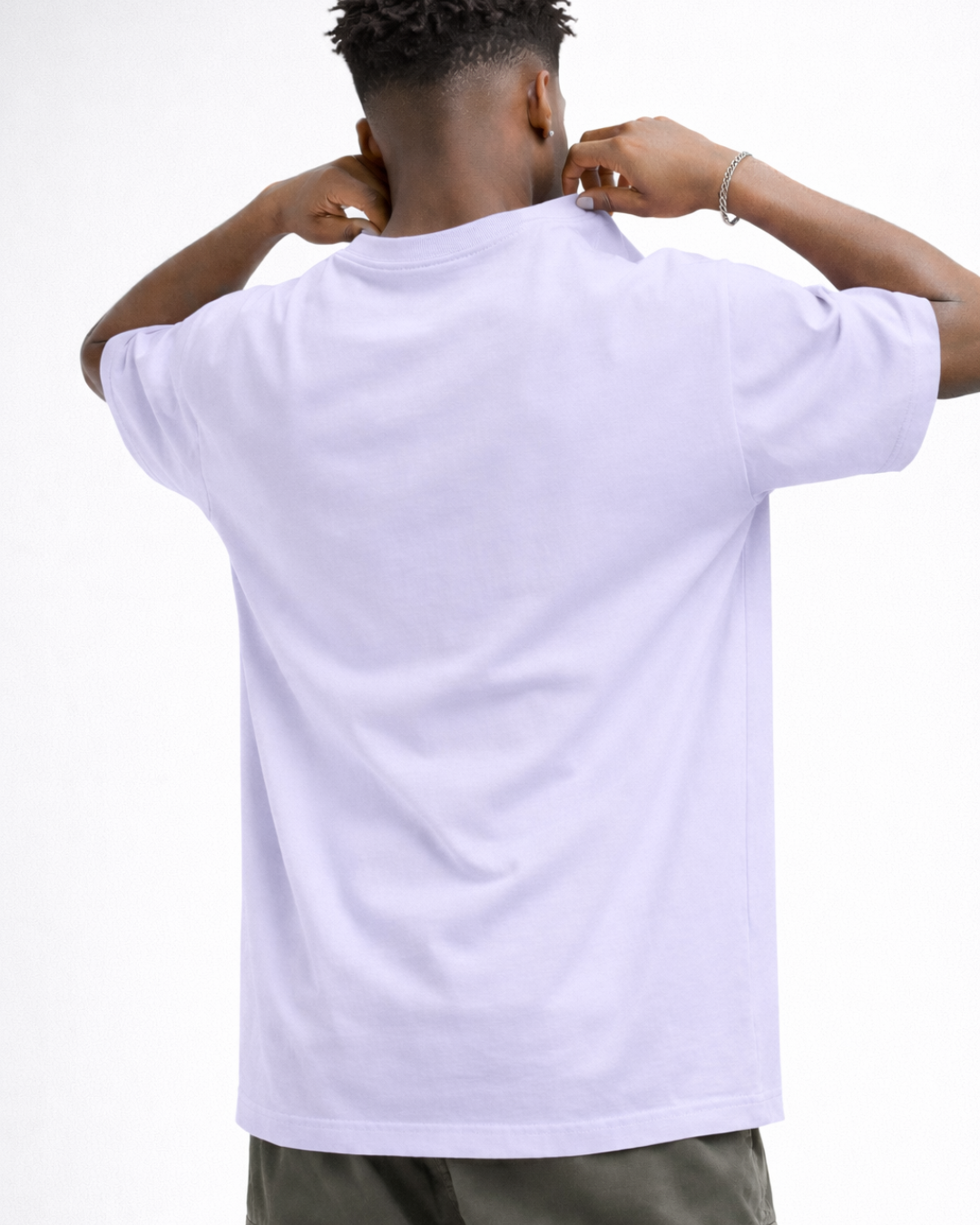 Person wearing a plain white t-shirt on a white background