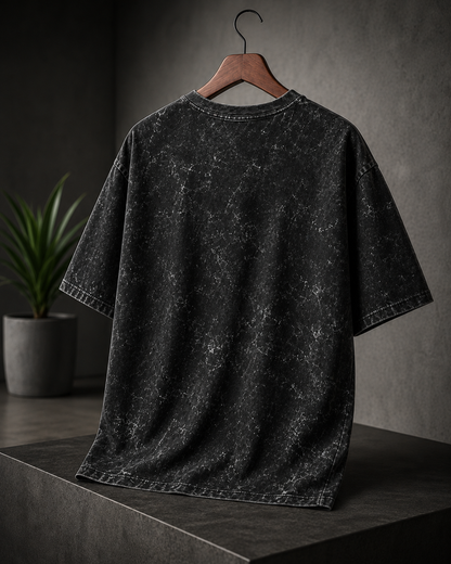 Unisex oversized black acid washed T-shirt with vintage distressed finish and relaxed streetwear fit from white bear brand