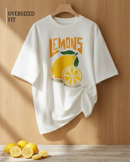 White t-shirt with lemon graphic and 'LEMONS' text on a wooden background
