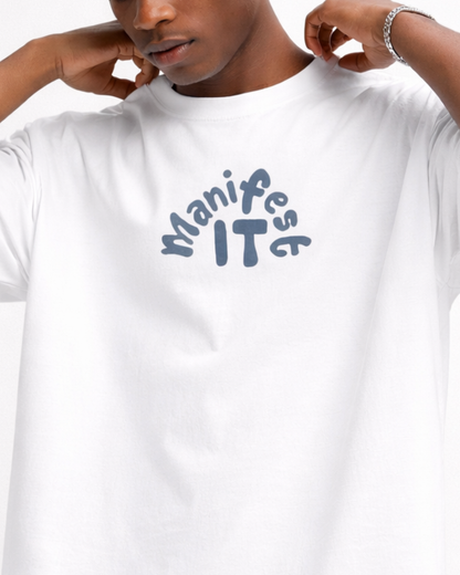 Person wearing a white t-shirt with 'Manifest IT' text in blue.
