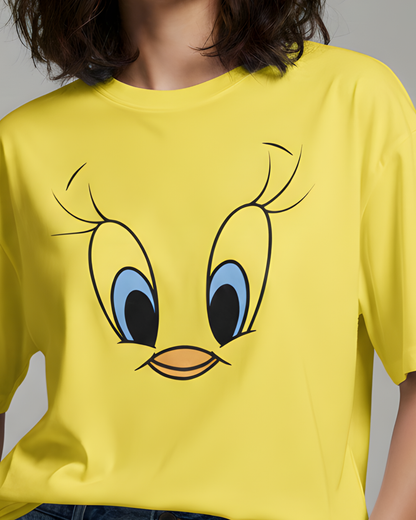 Yellow t-shirt with a cartoon face design on a plain background
