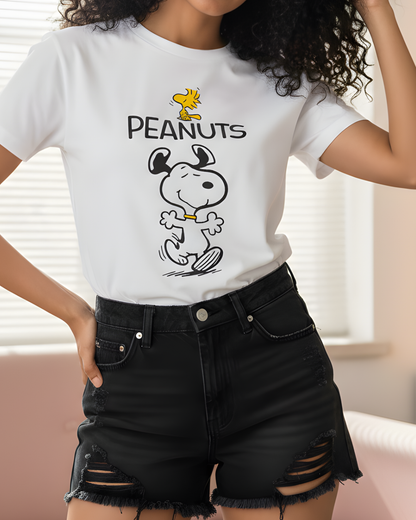 Person wearing a white t-shirt with a Peanuts graphic design.