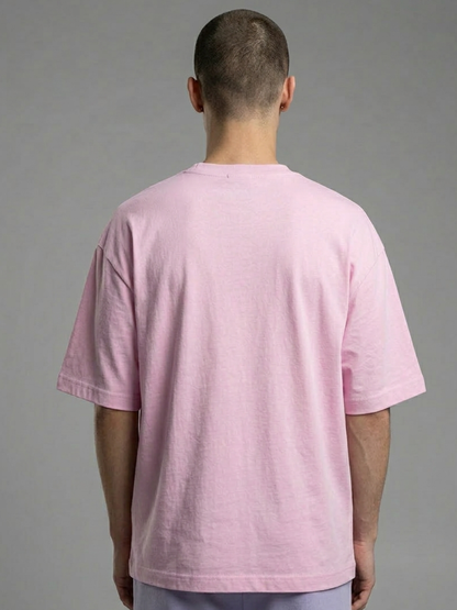 Person wearing a pink t-shirt against a gray background