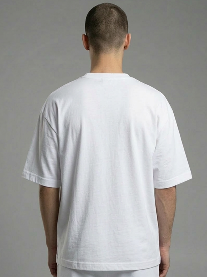 Person wearing a plain white t-shirt against a gray background