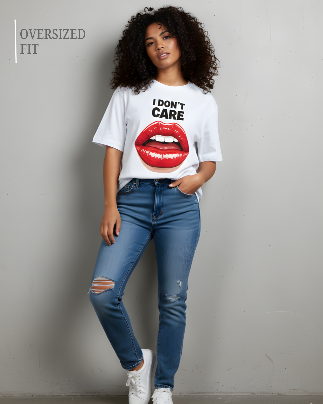 Person wearing a white t-shirt with a graphic and text, blue jeans, and white sneakers on a plain background.