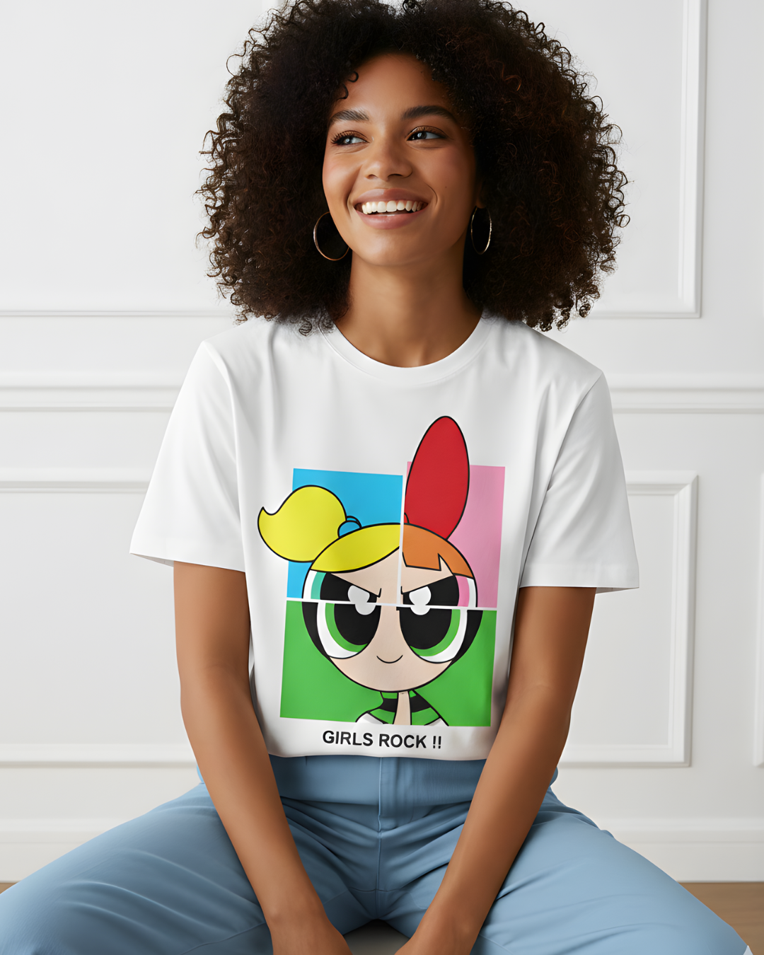 Woman wearing a white t-shirt with a colorful graphic design and 'Girls Rock!' text.