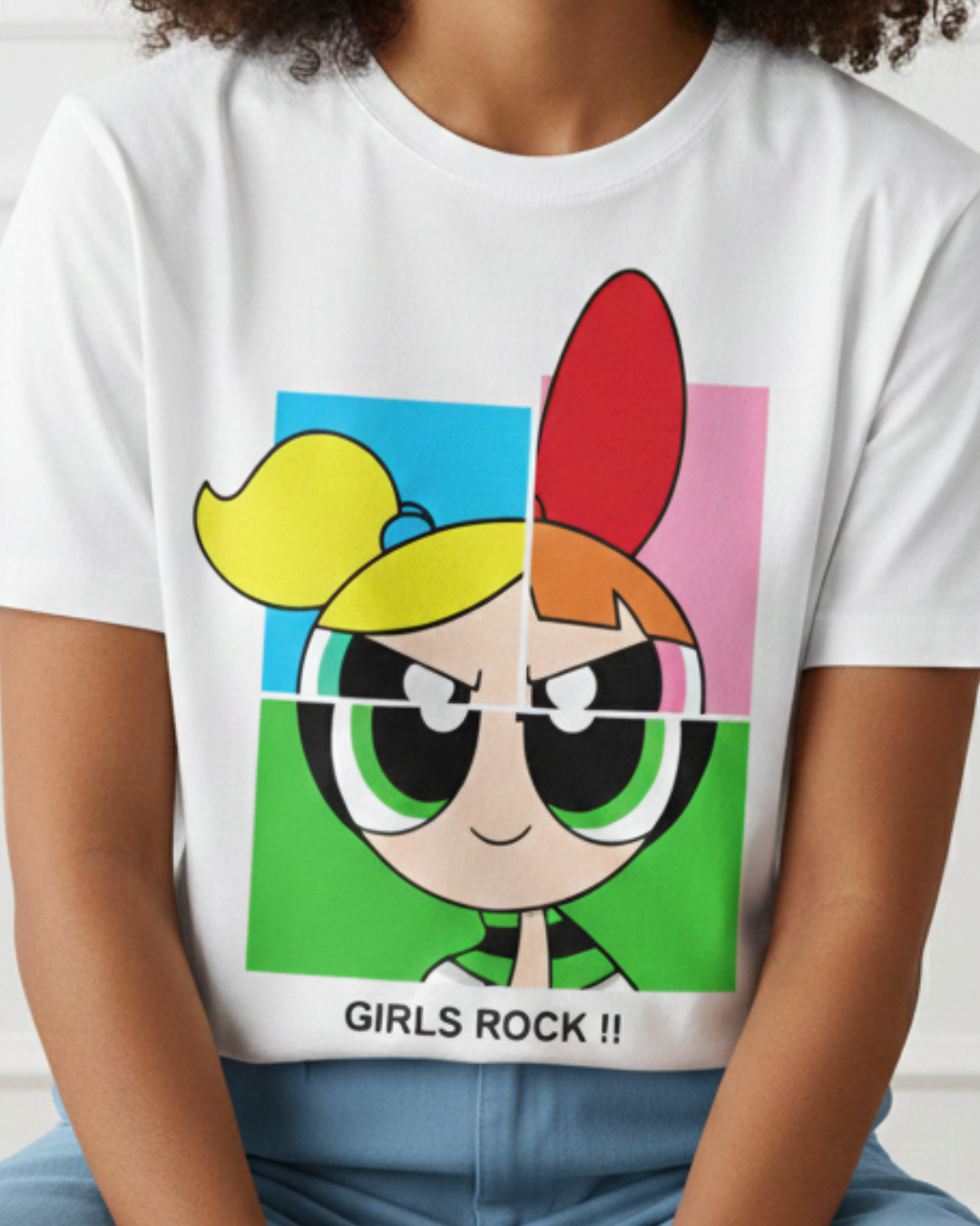 Person wearing a white t-shirt with a colorful graphic of a character and 'Girls Rock!' text.